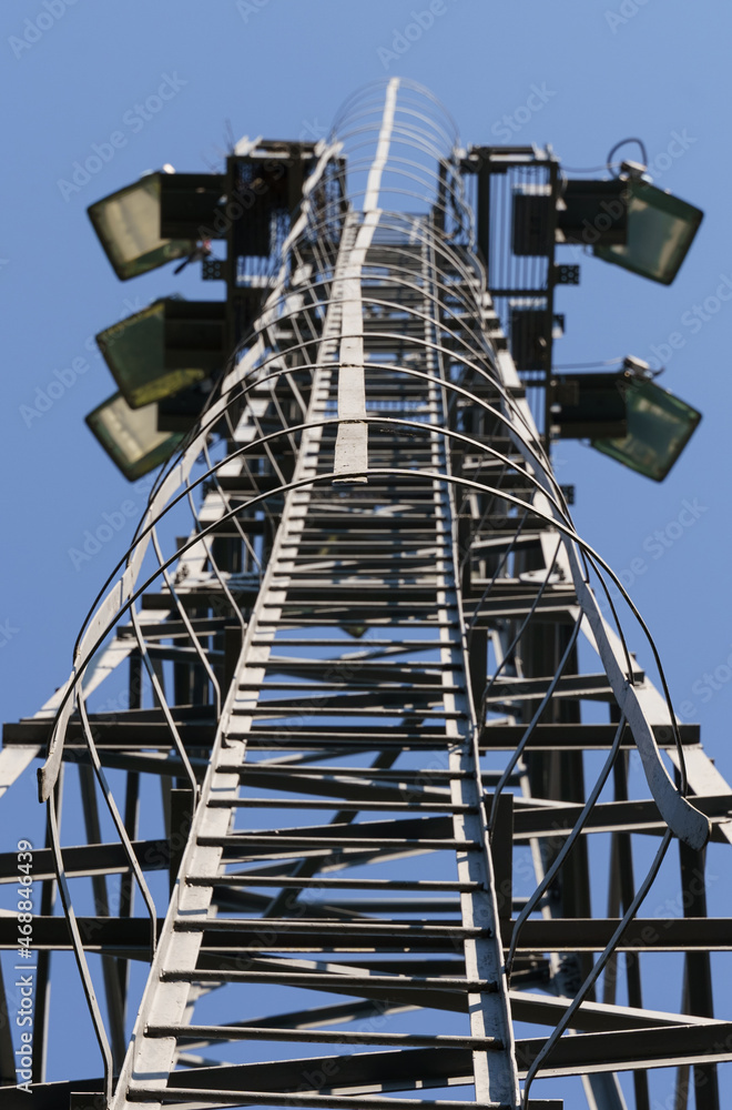 Lighting tower, bottom view of the tower against the sky.