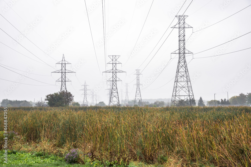 High voltage electricity pylons on a foggy autumn day