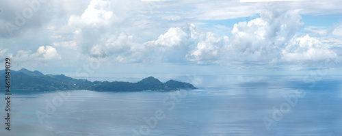 Wonderful panoramic ocean views in cloudy weather. A small island in the distance. Seychelles.
