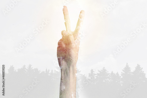 Double exposure of human hand with peace symbol. Ecology concept against climate change. © Fabián Montaño