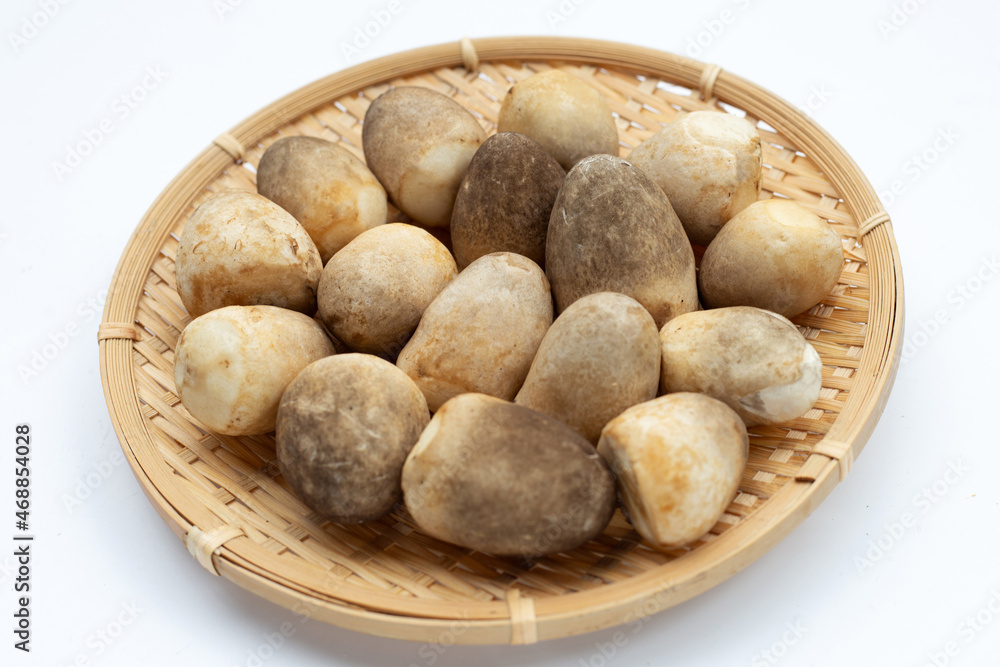 Straw mushroom in round bamboo basket on white background. Straw mushroom in round bamboo basket on white background.