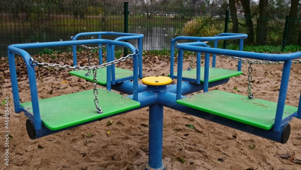 Empty Carousel Spinning on Public Playground