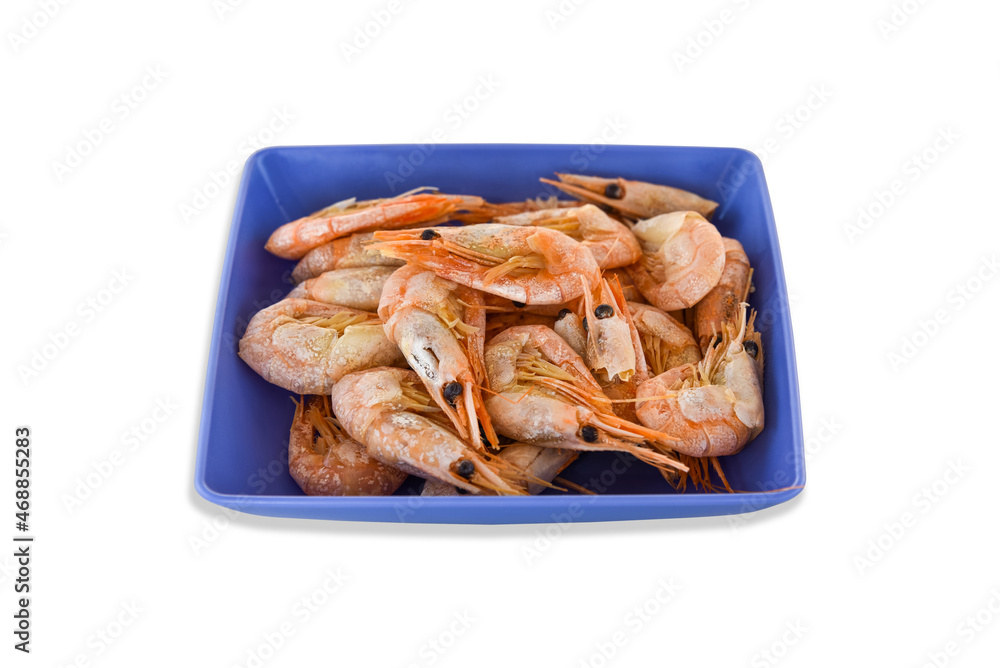 Cooked fresh shrimps on a blue plate isolated on white background. Seafood healthy food Cooked fresh shrimps on a blue plate isolated on white background. Seafood healthy food