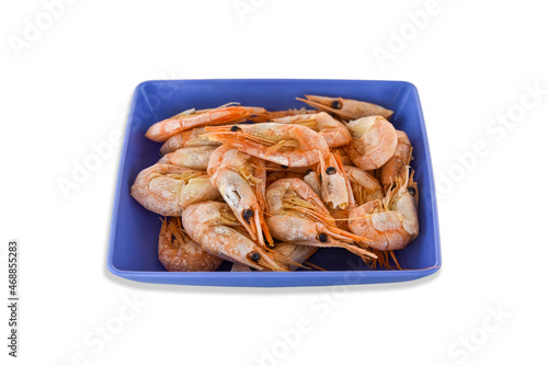 Cooked fresh shrimps on a blue plate isolated on white background. Seafood healthy food © Konstantin