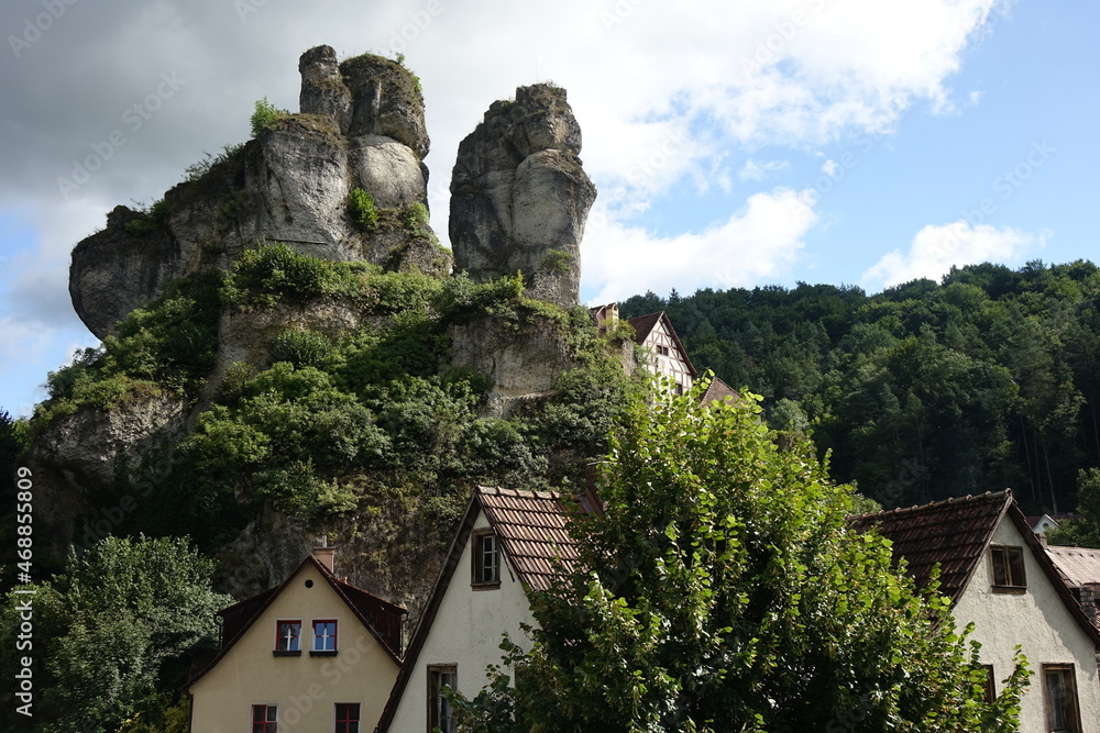 Famous rocks with lookout point Fahnenstein over traditional German framework houses, Tüchersfeld, Pottenstein, Upper Franconia, Bavaria, Germany

