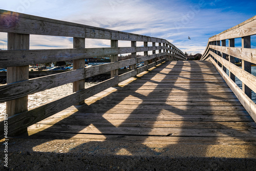 Plymouth Breakwater bridge over the Plymouth Jetty. Low angle view over the footpath of the weathered wooden bridge in the harbor.