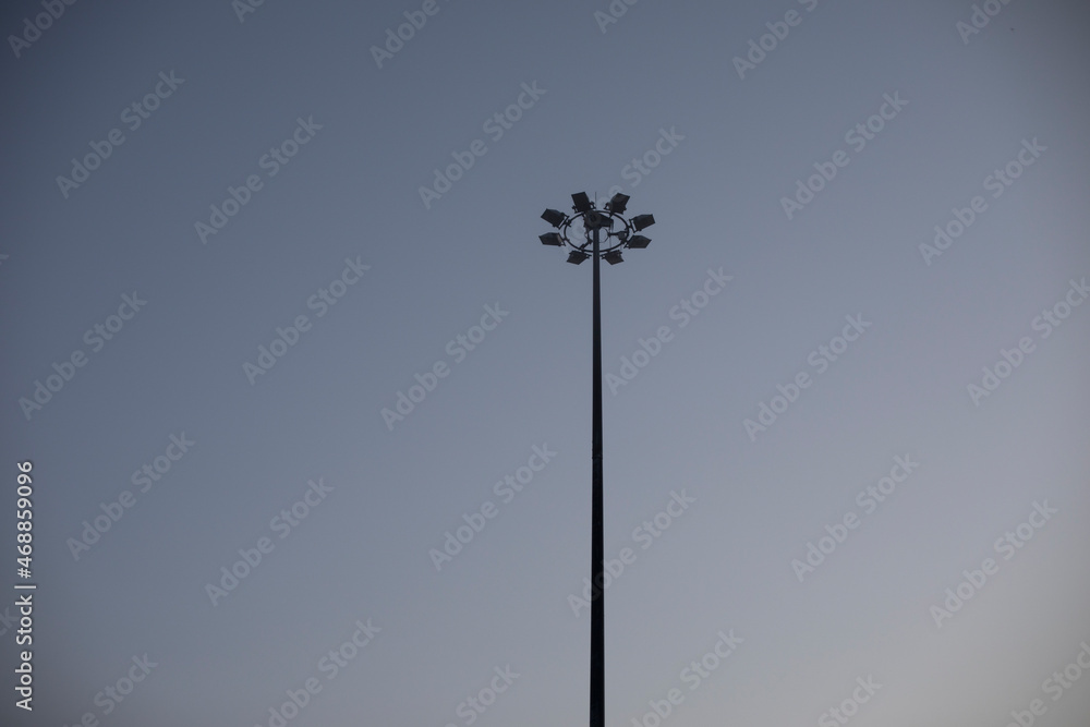 Black lantern against the background of a clear blue sky. Early morning on the street of the city. Moderate lighting. Black lantern against the background of a clear blue sky. Early morning on the street of the city. Moderate lighting.