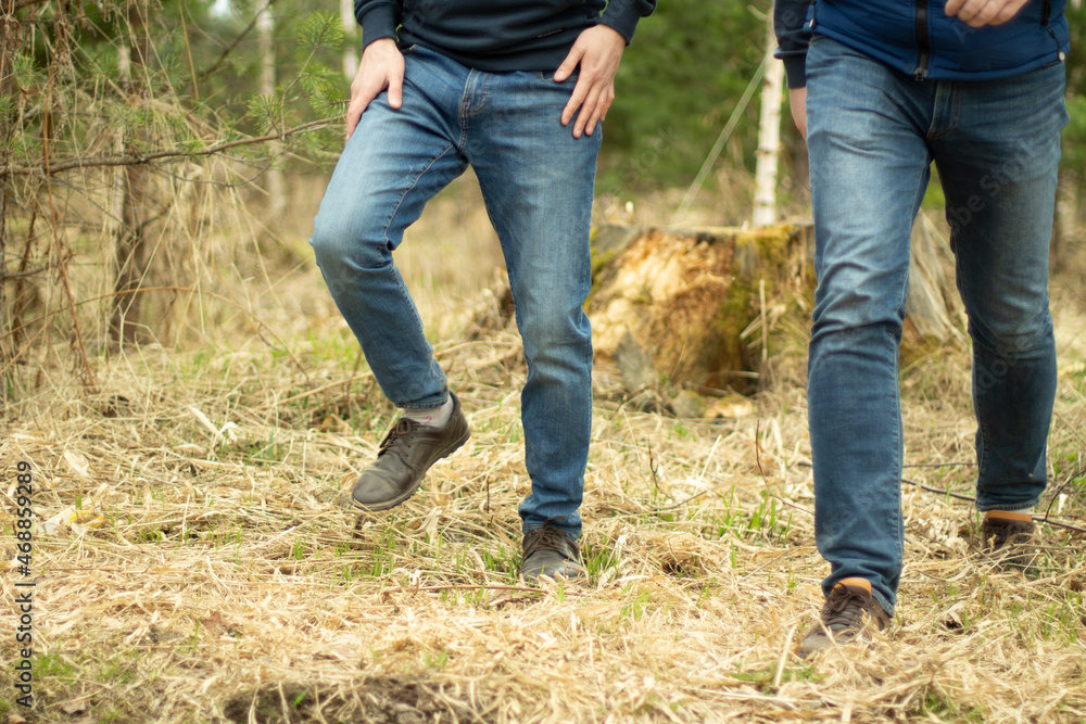 Two men in jeans. Fashion in clothes in autumn. Guys move freely. Two men in jeans. Fashion in clothes in autumn. Guys move freely.