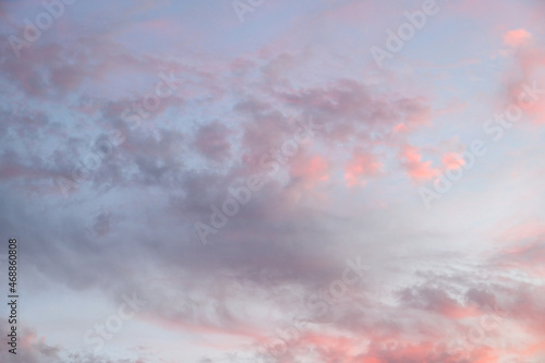 Soft and subtle cloudscape in pastels of evening light, as a nature background 