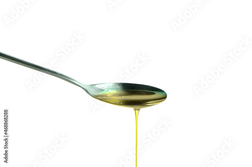 Pouring olive oil in the a spoon at kitchen. Prepare for cooking concept. Healthcare and Beauty Concept. on isolated white background