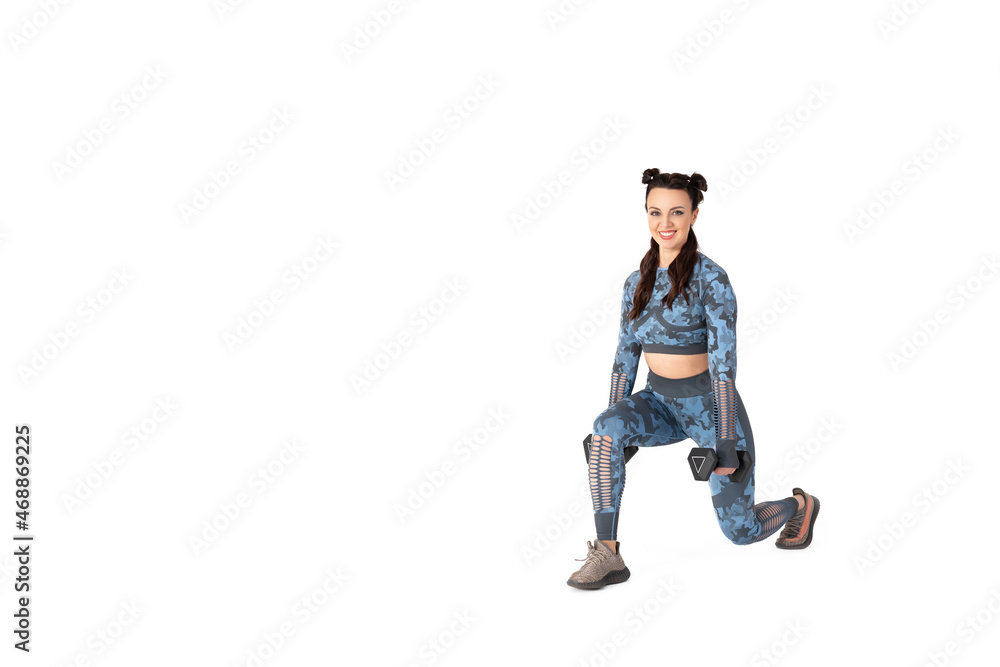 Beautiful sportive woman is engaged in fitness.Is doing exercise with dumbbells on an isolated white background. Smiling and looking at the camera. Sports and healthy lifestyle Beautiful sportive woman is engaged in fitness.Is doing exercise with dumbbells on an isolated white background. Smiling and looking at the camera. Sports and healthy lifestyle