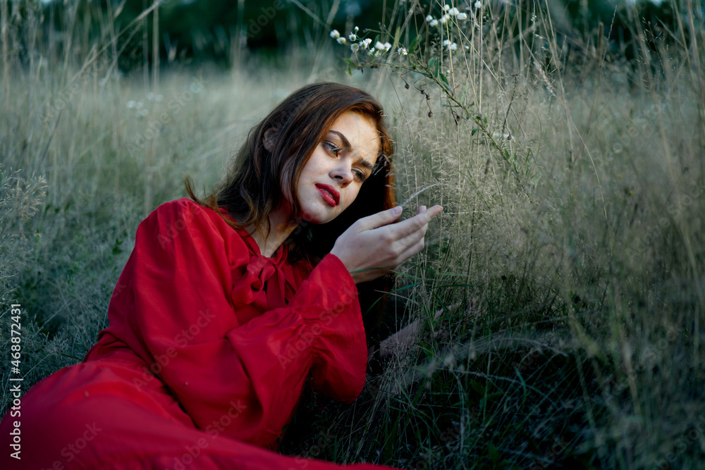 woman in red dress lies on the grass nature freedom rest woman in red dress lies on the grass nature freedom rest