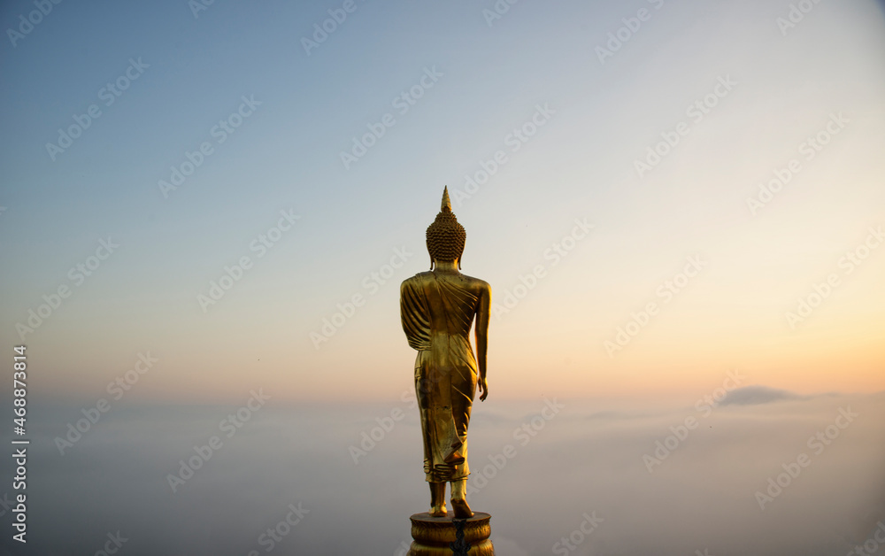Big golden buddha statue standing in Wat Phra That Kao Noi on morning at Nan province Thailand