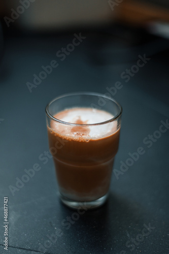 Dirty Coffee - A glass of espresso shot mixed with cold fresh milk in coffee shop cafe and restaurant