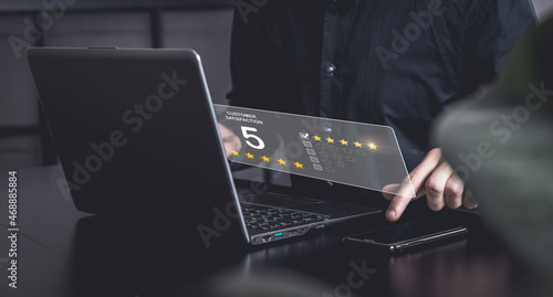 Business men is typing a costumer satisfaction on his smartphone