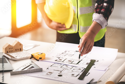 architect concept, working architect with blueprints in office to present to customers