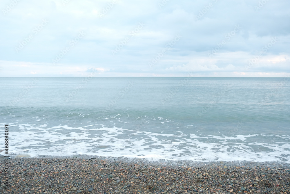 pebbles on the black sea coast. small waves on the shores of the black sea covered with pebbles pebbles on the black sea coast. small waves on the shores of the black sea covered with pebbles