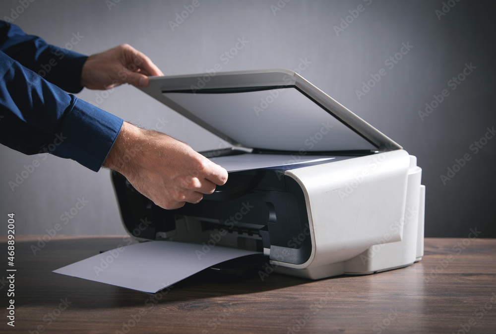 Man copying and scanning documents in office. Man copying and scanning documents in office.