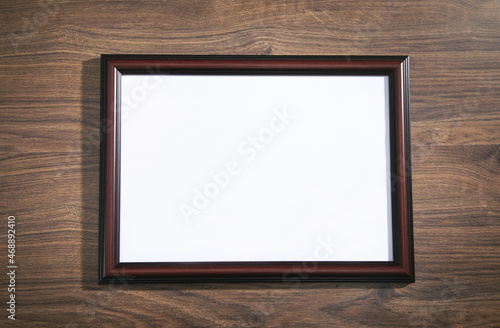 Empty diploma or certificate frame on the table.