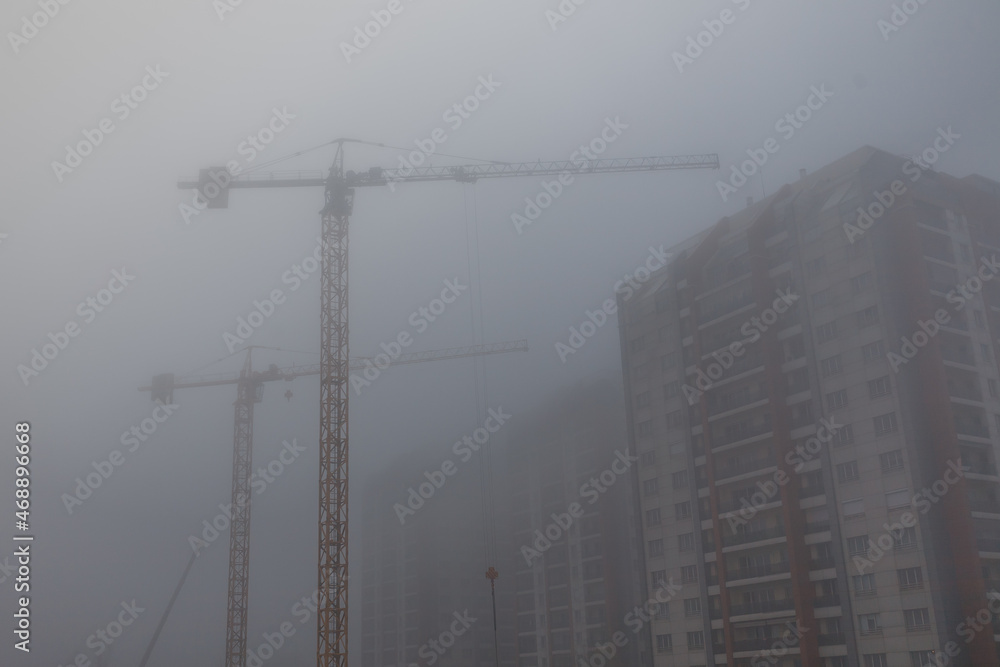 Heavy duty cranes in the morning mist Heavy duty cranes in the morning mist