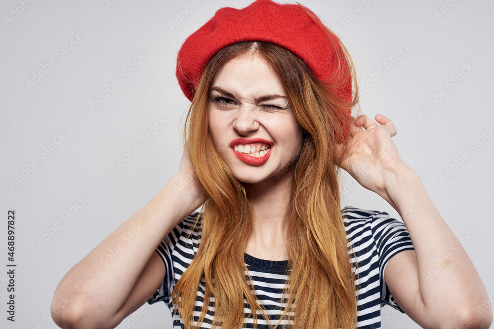 beautiful woman in a striped t-shirt red lips gesture with his hands Fresh air beautiful woman in a striped t-shirt red lips gesture with his hands Fresh air