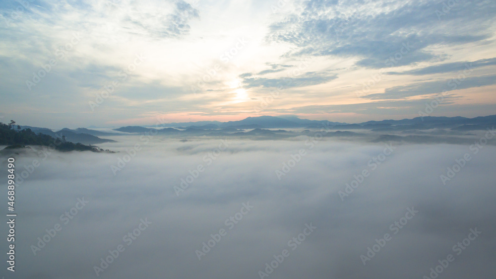 Fototapeta premium aerial view mist above the mountain in tropical rainforest and .beautiful sunrise scenery view in Phang Nga valley.