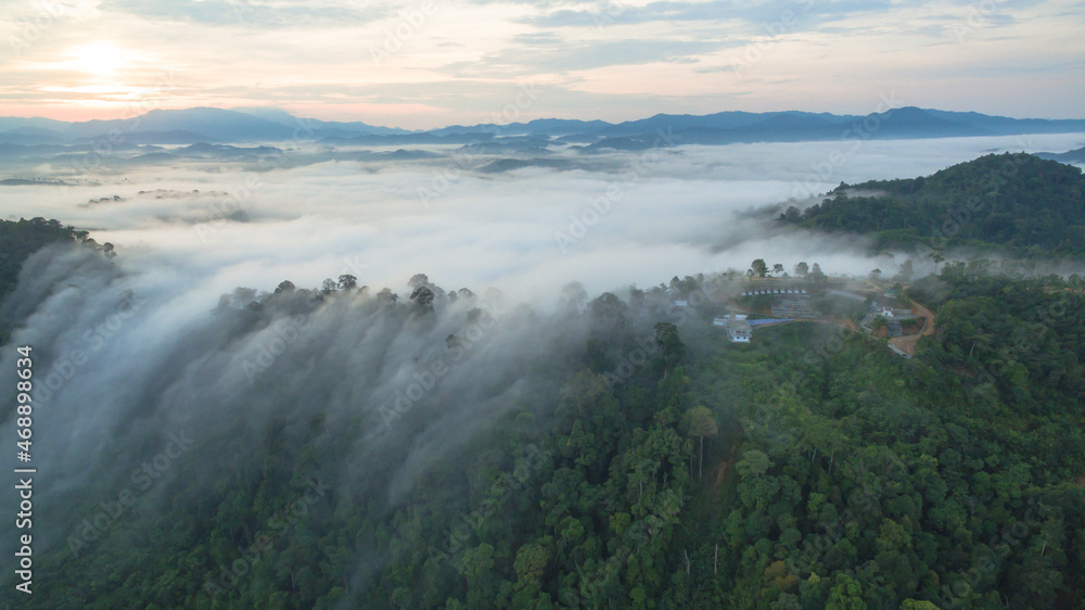 aerial view mist above the mountain in tropical rainforest and .beautiful sunrise scenery view in Phang Nga valley.