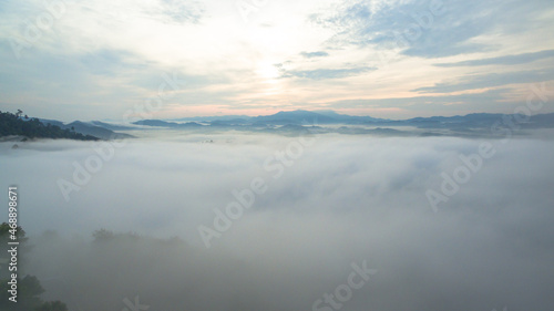 aerial view mist above the mountain in tropical rainforest and .beautiful sunrise scenery view in Phang Nga valley. © Narong Niemhom