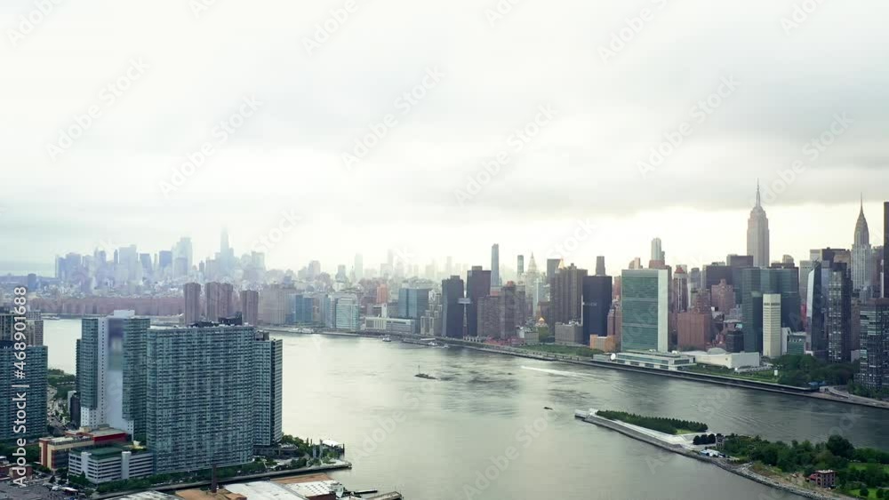 Tall High Rise Buildings In New York Cut Through Sky. Famous Unsurpassed City In All Its Glory. City Is Surrounded By River. Tall High Rise Buildings In New York Cut Through Sky. Famous Unsurpassed City In All Its Glory. City Is Surrounded By River.