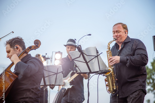 Photography Male saxophonist playing in orchestra on the street