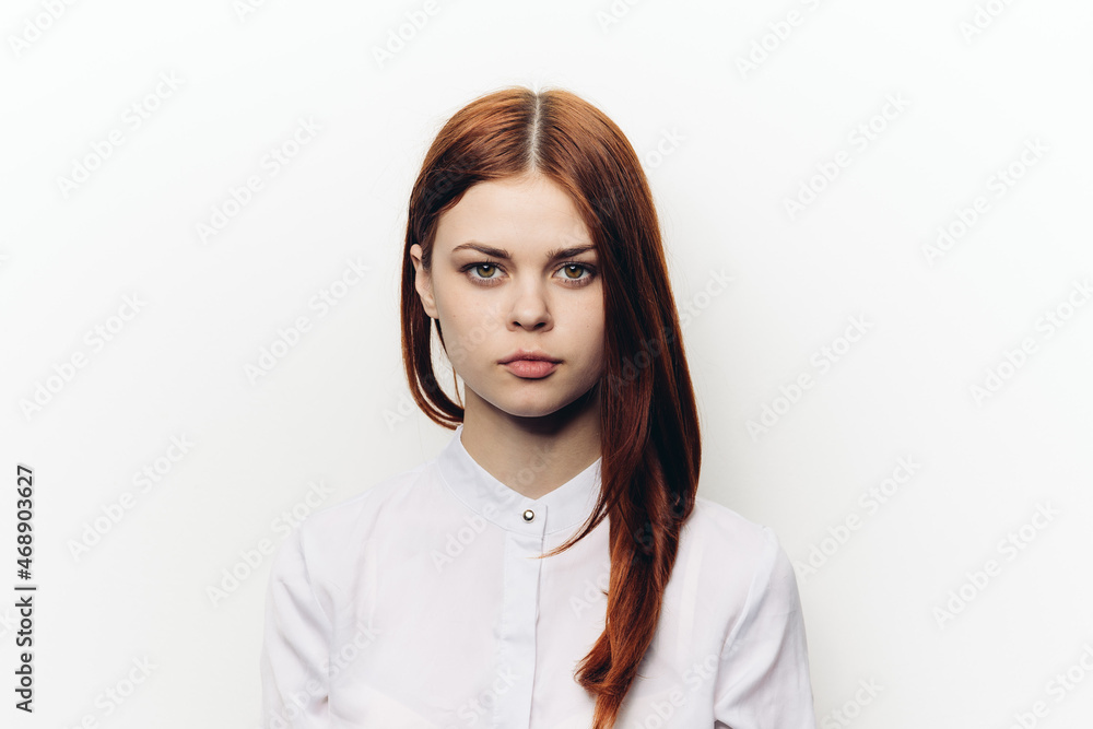 pretty red-haired woman in white shirt light background pretty red-haired woman in white shirt light background
