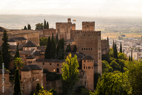 The Nasrid fortification of the Alhambra de Granada with the towers of the Nasrid Palaces, the Alcazaba fortress and the Palace of Charles V in beautiful evening light, Granada, Andalusia, Spain