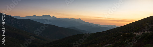 sunset over the corsican mountains near saint florent ,corsica France , soft layered misty colours ,with copy space .