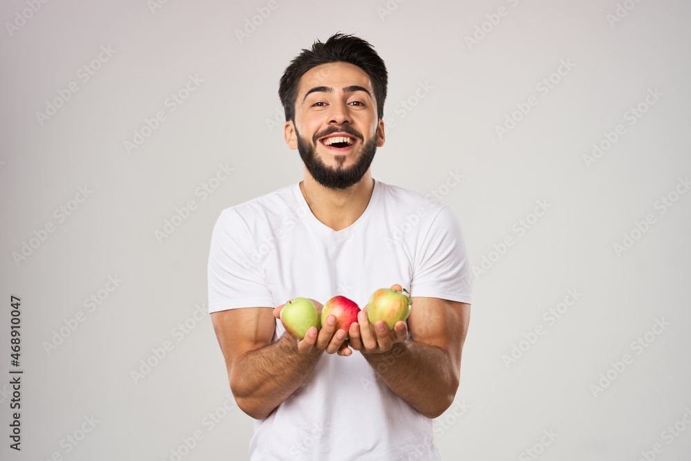 bearded man in white t-shirt apples holding healthy food bearded man in white t-shirt apples holding healthy food