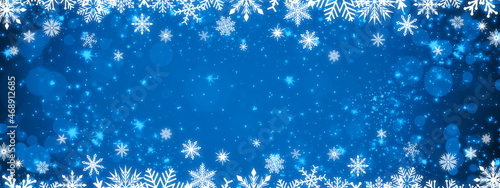 Frame with snowflakes on a blue gradient background with bokeh and sparkles. Festive New Year and Christmas banner