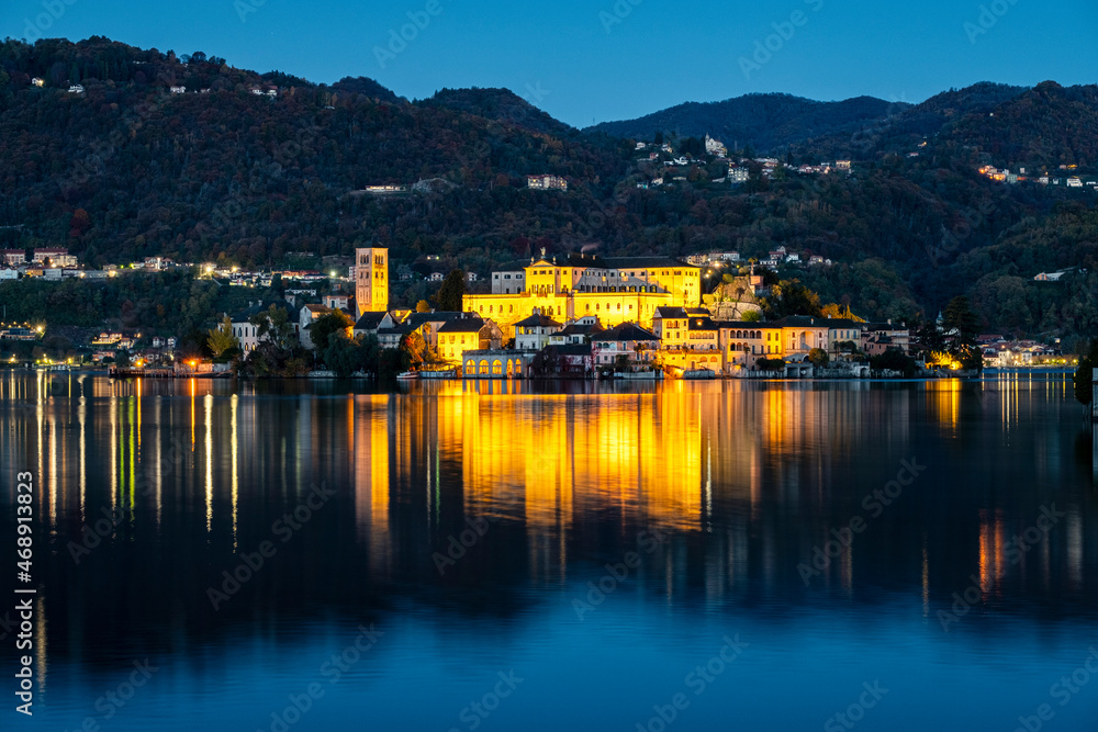 Winter early sunrise panorama of Orta San Giulio island, in the same name lake (Piedmont, Northern Italy); small lake of alpine origin, is UNESCO Site and home of a cloistered nuns convent.