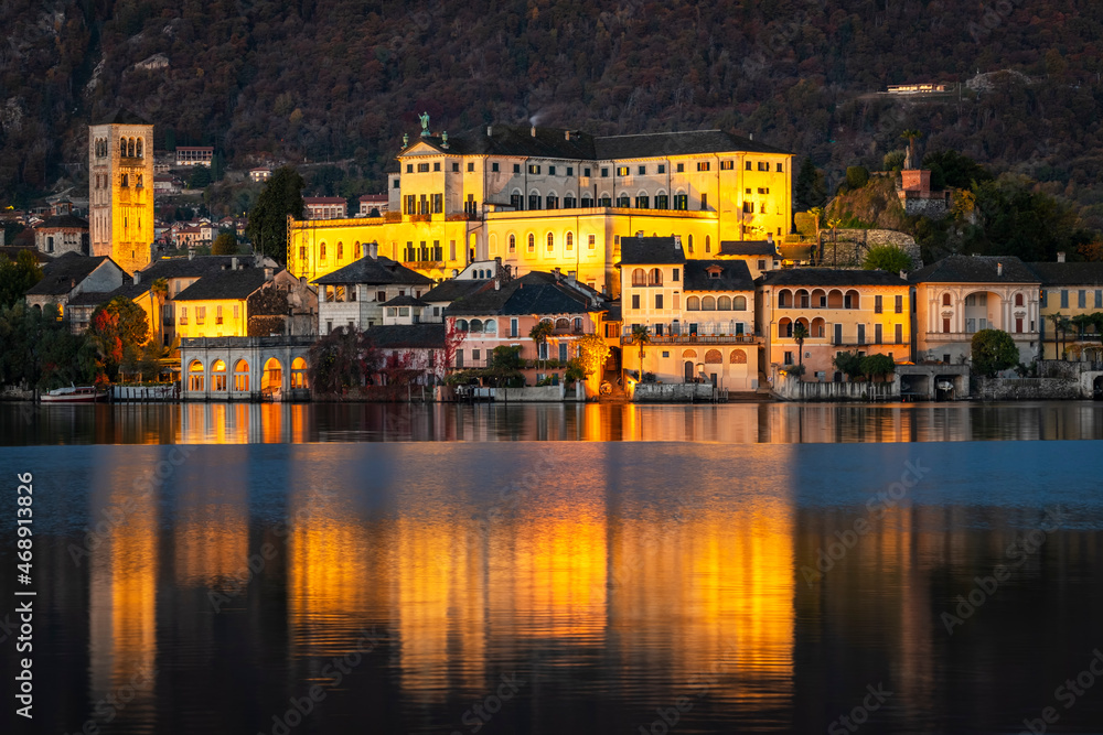 Winter early sunrise panorama of Orta San Giulio island, in the same name lake (Piedmont, Northern Italy); small lake of alpine origin, is UNESCO Site and home of a cloistered nuns convent.