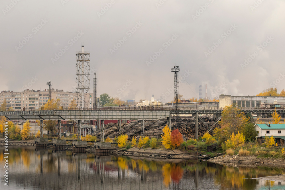 The infrastructure of a woodworking plant against the backdrop of an autumn landscape. Transport concept.
