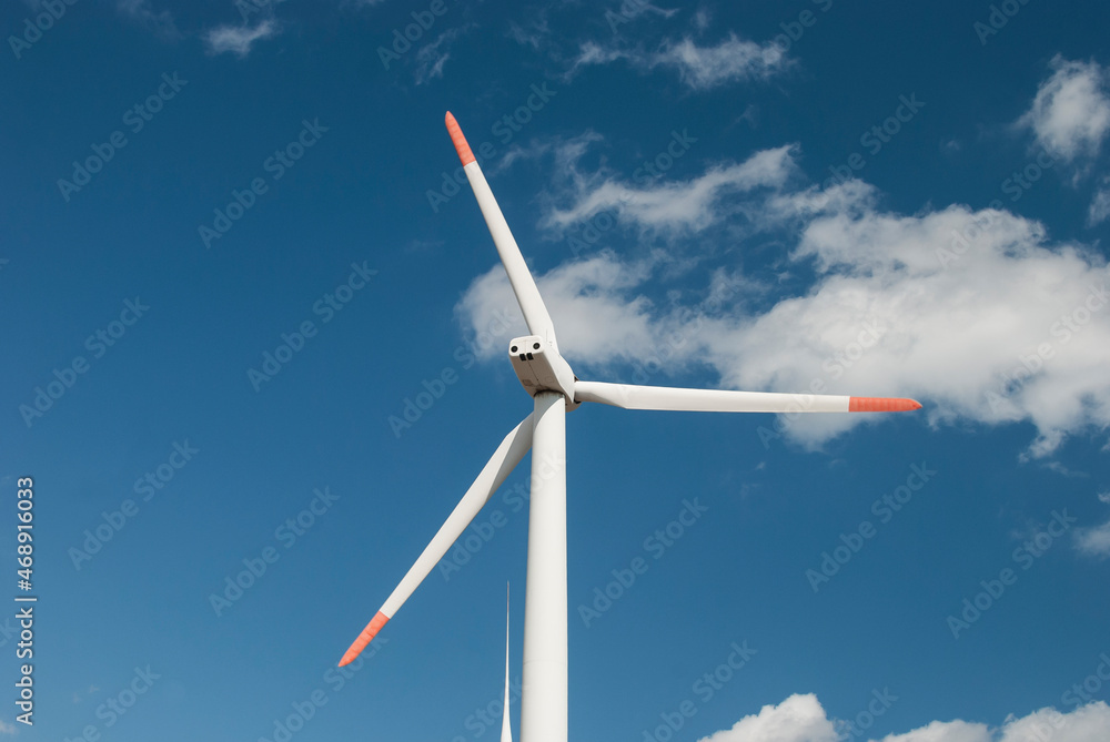Horizontal wind turbine generator closeup on blue sky background