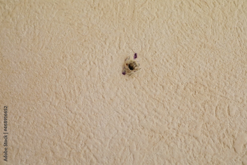 Hole in the wallpaper of the apartment. November 2021 Japan. Hole in the wallpaper of the apartment. November 2021 Japan.