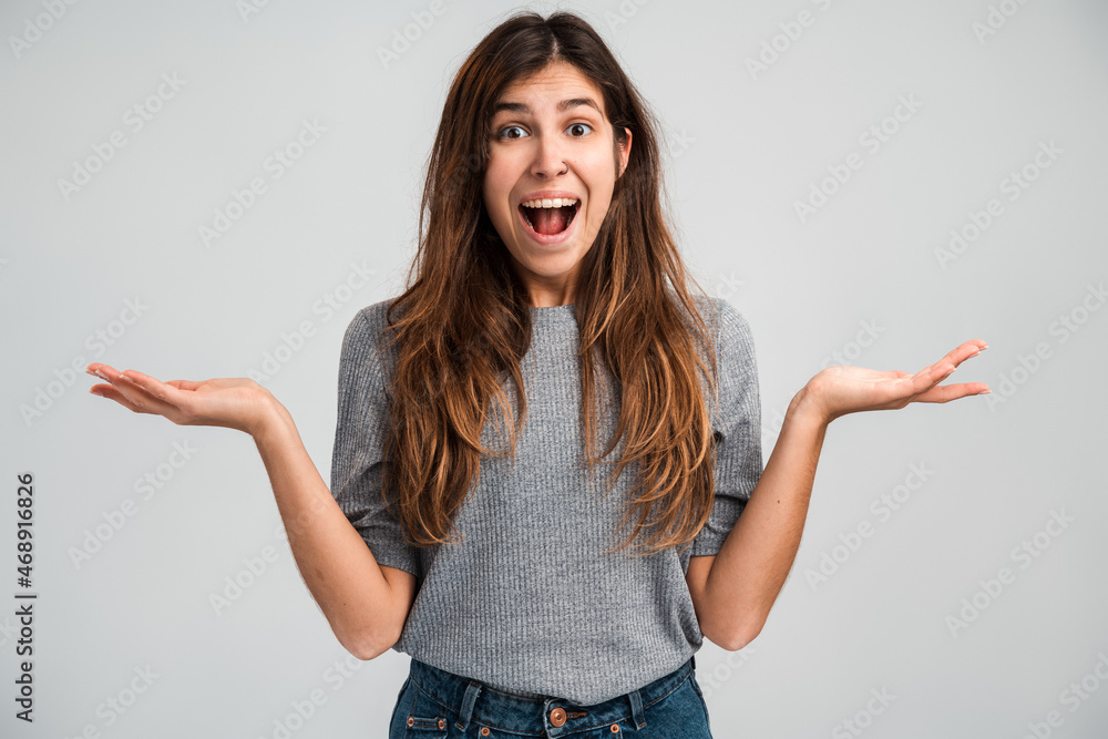 Portrait of happy rejoicing young woman with long hair in hat screaming and celebrating her victory with amazed excited face. Indoor studio shot isolated on white background Portrait of happy rejoicing young woman with long hair in hat screaming and celebrating her victory with amazed excited face. Indoor studio shot isolated on white background