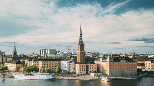 Stockholm, Sweden. Gamla Stan Is Famous Popular Place And Destination Scenic. Riddarholm Church In Sunny Summer Cityscape Skyline. Scenic View Of Embankment In Old Town. UNESCO World Heritage Site.