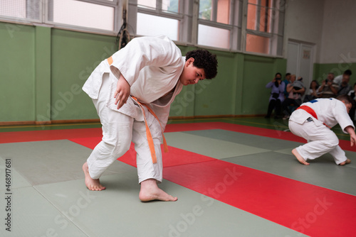 Two judo fighters showing technical skill while practicing martial arts in a fight club. The two fit men in uniform. fight, karate, training, arts, athlete, competition concept.Selective Focus