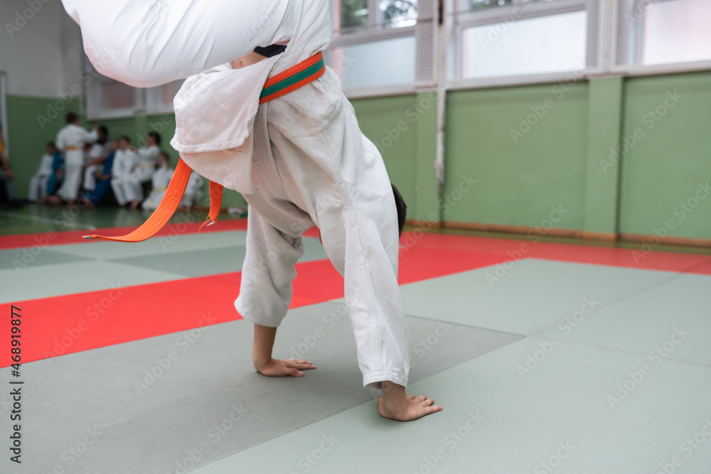 Two judo fighters showing technical skill while practicing martial arts in a fight club. The two fit men in uniform. fight, karate, training, arts, athlete, competition concept.Selective Focus Two judo fighters showing technical skill while practicing martial arts in a fight club. The two fit men in uniform. fight, karate, training, arts, athlete, competition concept.Selective Focus