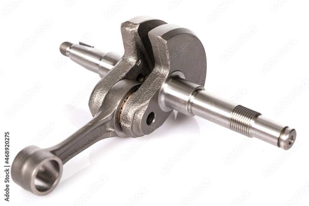 crankshaft made of metal on a white background, new engine spare part crankshaft made of metal on a white background, new engine spare part