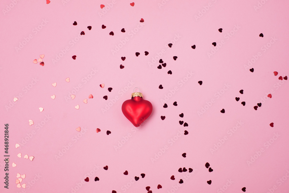 Red confetti in the form of hearts on a pink background and Decoration Valentines day backdrop Flat lay style with minimalistic design Template for banner or party invitation Red confetti in the form of hearts on a pink background and Decoration Valentines day backdrop Flat lay style with minimalistic design Template for banner or party invitation