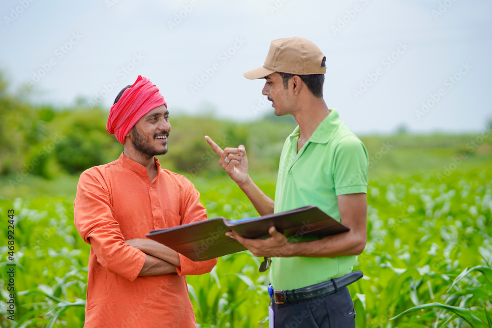 young india bank officer completing paper work with farmers at agriculture field. young india bank officer completing paper work with farmers at agriculture field.