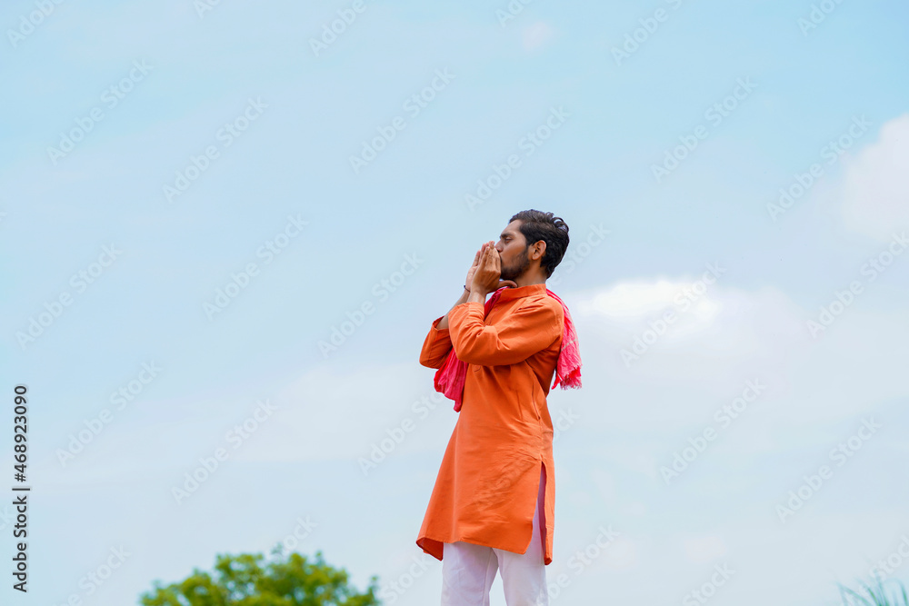 Indian farmer standing on bricks and watching on sky Indian farmer standing on bricks and watching on sky