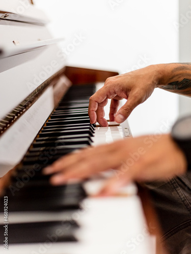 Close-up of man’s hand at the piano