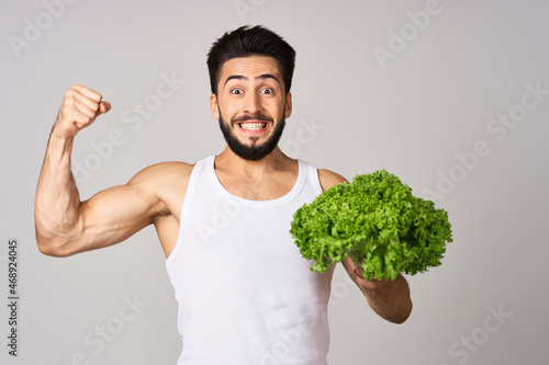 bearded man in white t-shirt lettuce leaf vegetables healthy food